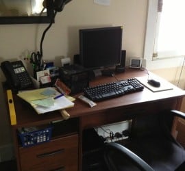 A wooden desk, assembled, with computer on top