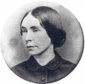 A round three-quarters profile of a woman in black and white. She has dark hair and wears a dreamy expression.