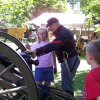 A participant learns to load a cannon in our Civil War encampment