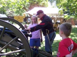 A participant learns to load a cannon in our Civil War encampment
