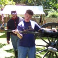 A participant learns to load a cannon in our Civil War encampment