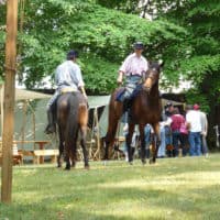 Civil War Cavalry reenactors on horseback in encampment