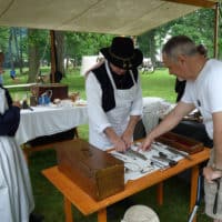 A reenactor portrays a surgeon in Civil War encampment