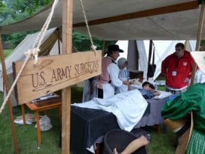 A reenactor portrays a surgeon in Civil War encampment