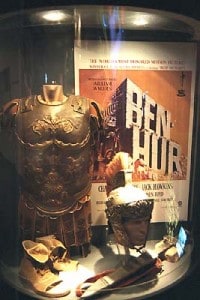 Breastplate, helmet, and other props used during the filming of the 1959 Ben-Hur. A movie poster is in the background.