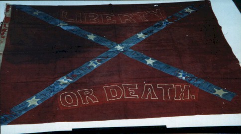 Confederate Flag of the Nighthawk Rangers, a Confederate cavalry unit. It has a dark red background, a blue diagonal cross, with white stars in it.