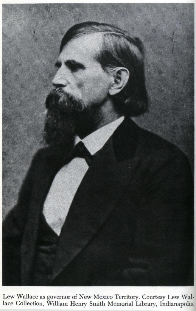 Black and white three-quarters profile of Lew Wallace as Territorial Governor of New Mexico. He has a black beard and black hair and wears a dark suit.