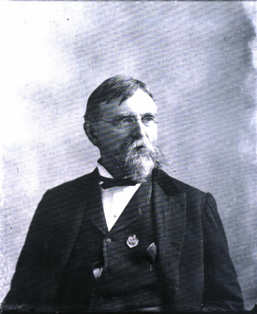 Lew Wallace as an older man. He has gray hair and beard and wears a dark suit.
