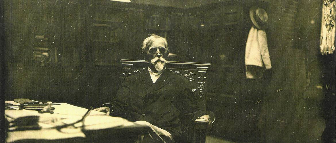 Lew Wallace sits in a chair facing the camera inside his Study