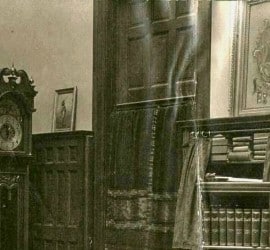 An historic photo of the interior of the Study, casement clock, and Ben-Hur sculpture