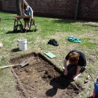 Archaeology workers begin a trench on the Study grounds.