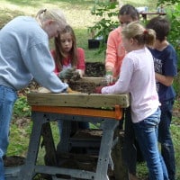 Workers screen dirt during History Beneath Us archaeology