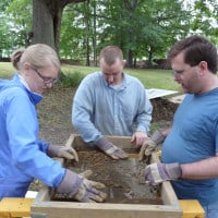 Workers screen dirt during History Beneath Us archaeology