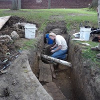 Archaeology in a trench in the reflecting pool