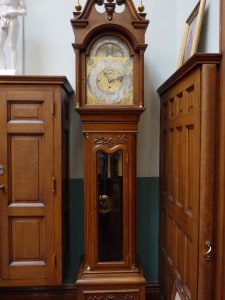 A grandfather clock commissioned from Tiffany and Company. It is made of quarter-sawn white oak and stands in a corner of the Stuy.