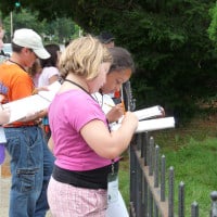 ArchiCamp participants draw a house during their walking tour of Crawfordsville.