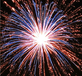 Red, white, and blue fireworks explode against a night sky; image by Kevin Dooley
