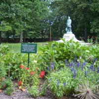 Tee's Garden is full of flowers with the statue of Lew Wallace in the background