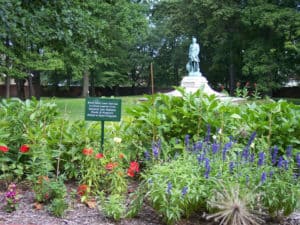 Tee's Garden is full of flowers with the statue of Lew Wallace in the background