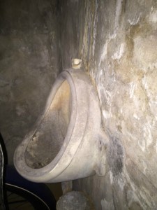 An 1890s urinal placed in a small bathroom in the Study basement