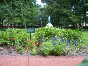 Tee's Garden is full of flowers with the statue of Lew Wallace in the background