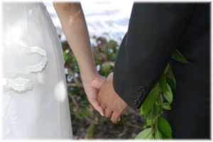 A bride and groom hold hands at the wedding
