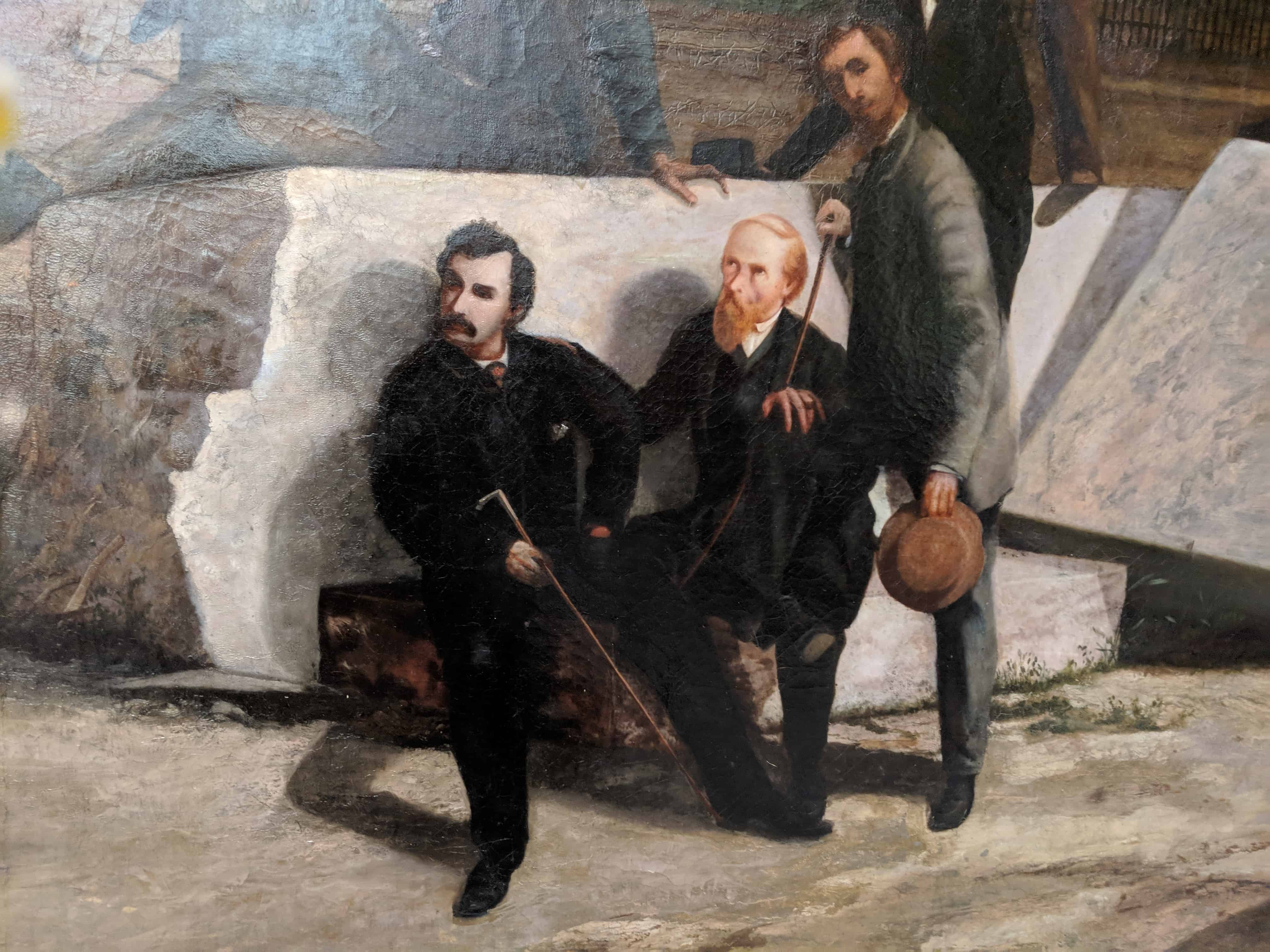 Three men in front of large stone blocks. Close-up of Lew Wallace's painting of the Lincoln Conspirators (oil on canvas)