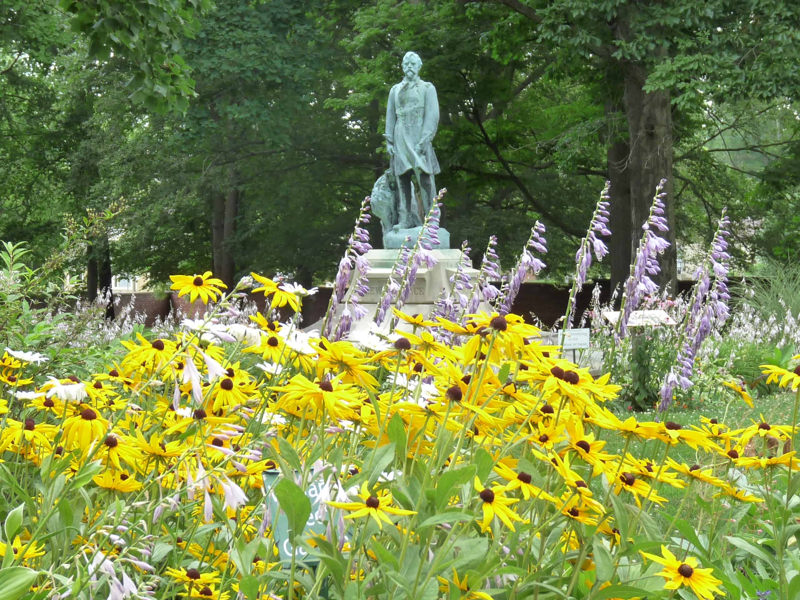 Statue of Lew Wallace with yellow flowers in front of it
