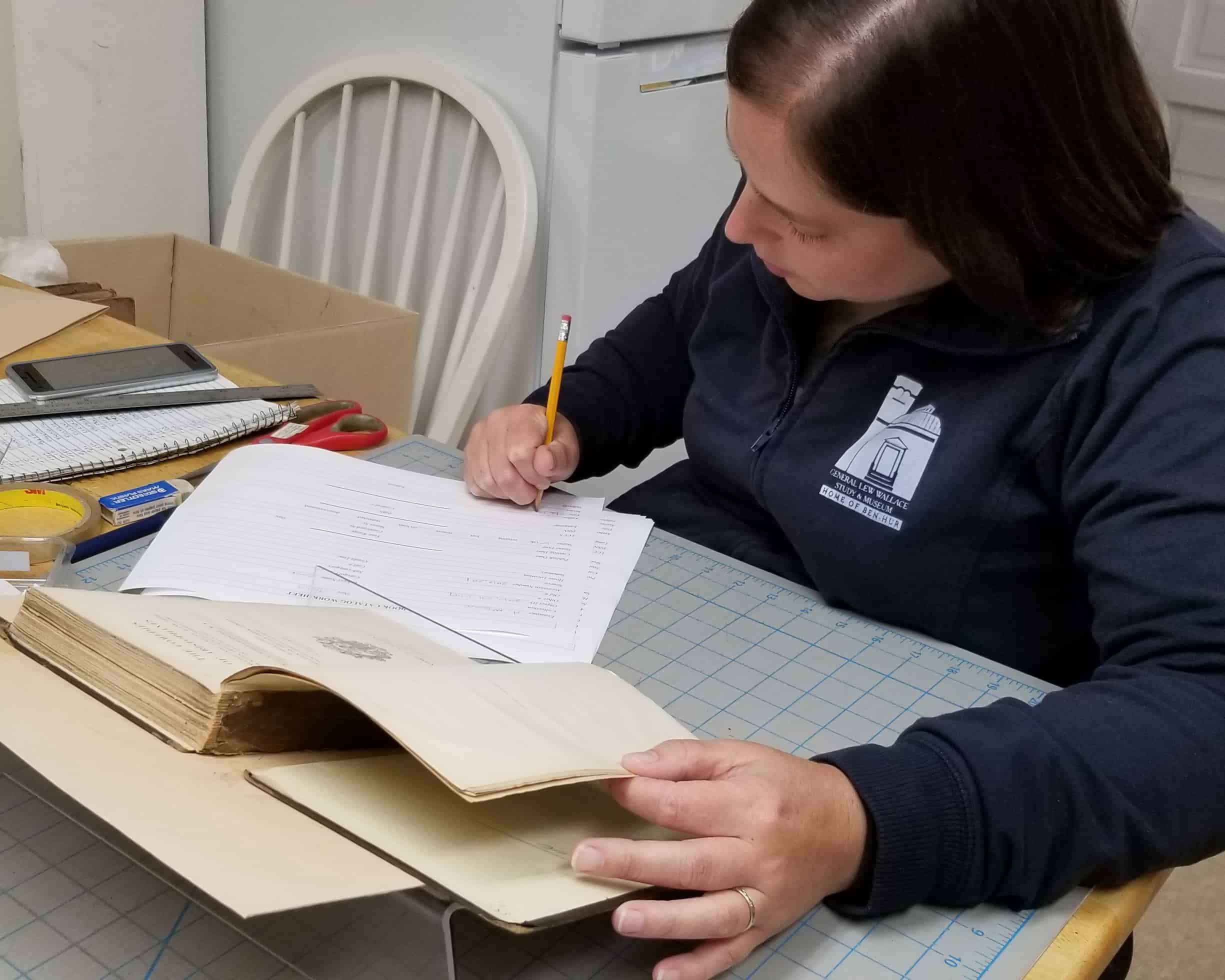 Associate Director Amanda McGuire works on book conservation
